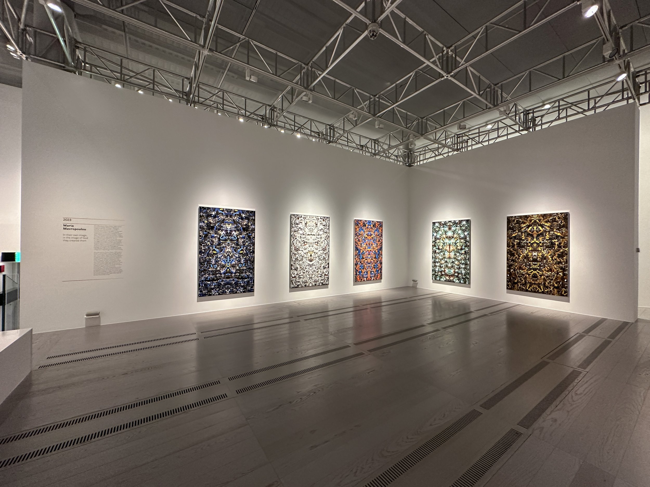 5 quadri su muro bianco, illuminati da dietro. Foto artistiche generate da IA con immagini specchiate.